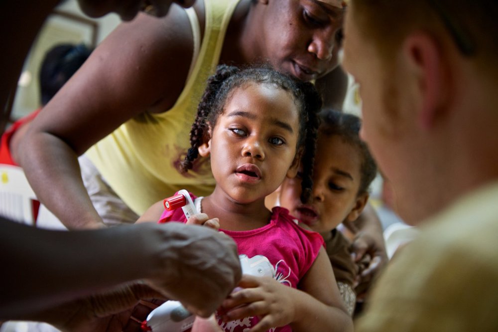 Miracle Malaki, a&nbsp;visually impaired student at the BCVI Summer Camp in Belize City, Belize, receives a self-powered radio from Ears to Our World. (Photo: David Korchin)